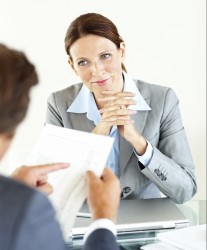business woman sitting with a client to fix a deal