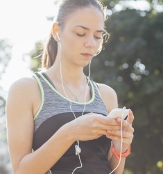 test Young lady setting the music playlist for the workout