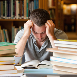 test Tired student having a lot to read in a library